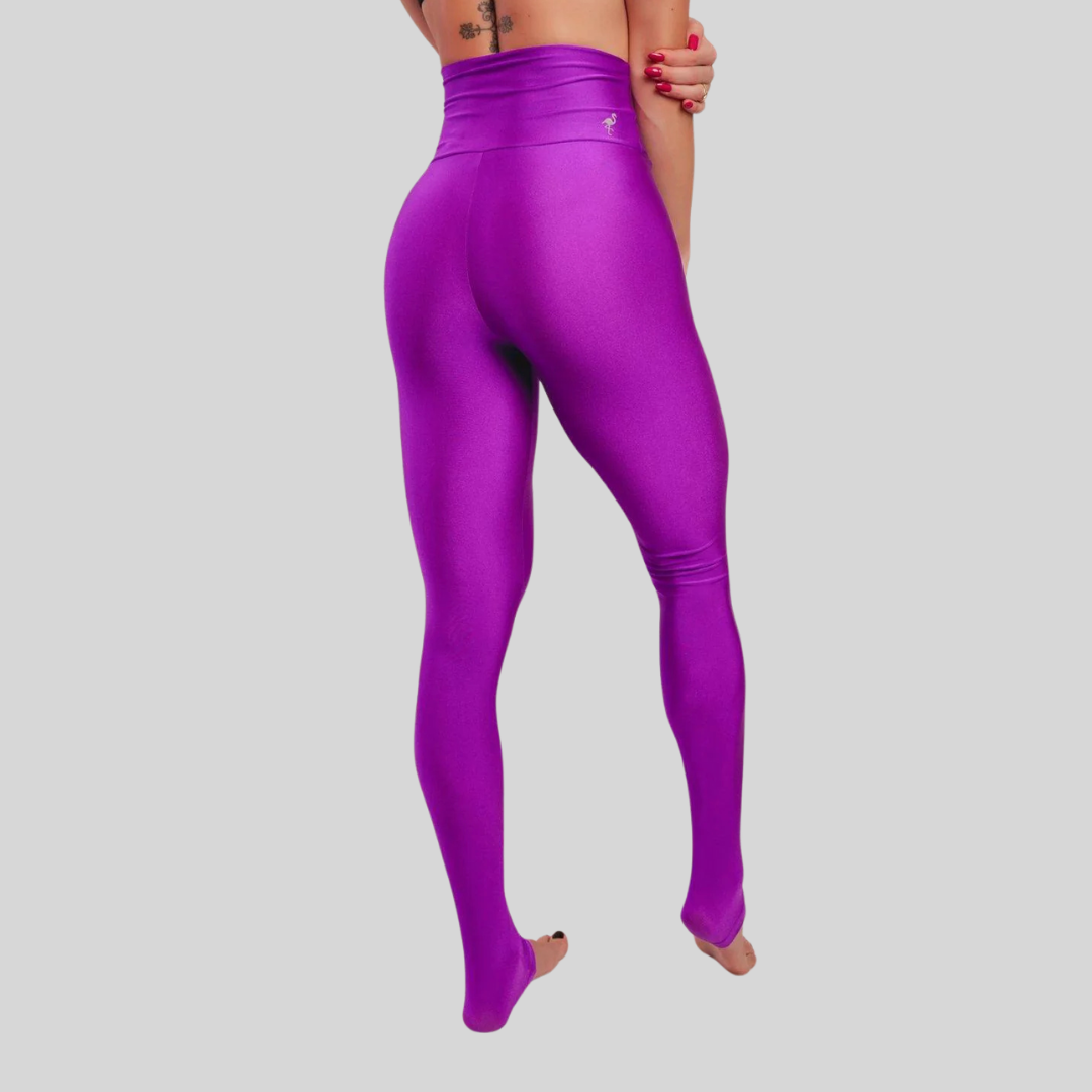 Purple leggings worn by a person on a gray background