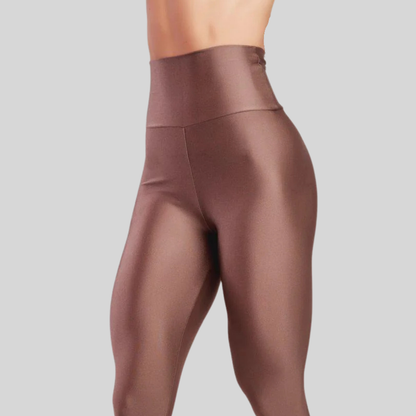 Brown leggings worn by a person on a gray background