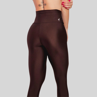 Brown leggings worn by a person on a gray background