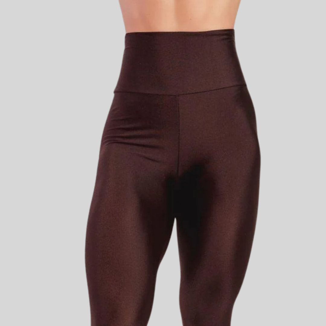 Brown leggings worn by a person on a gray background