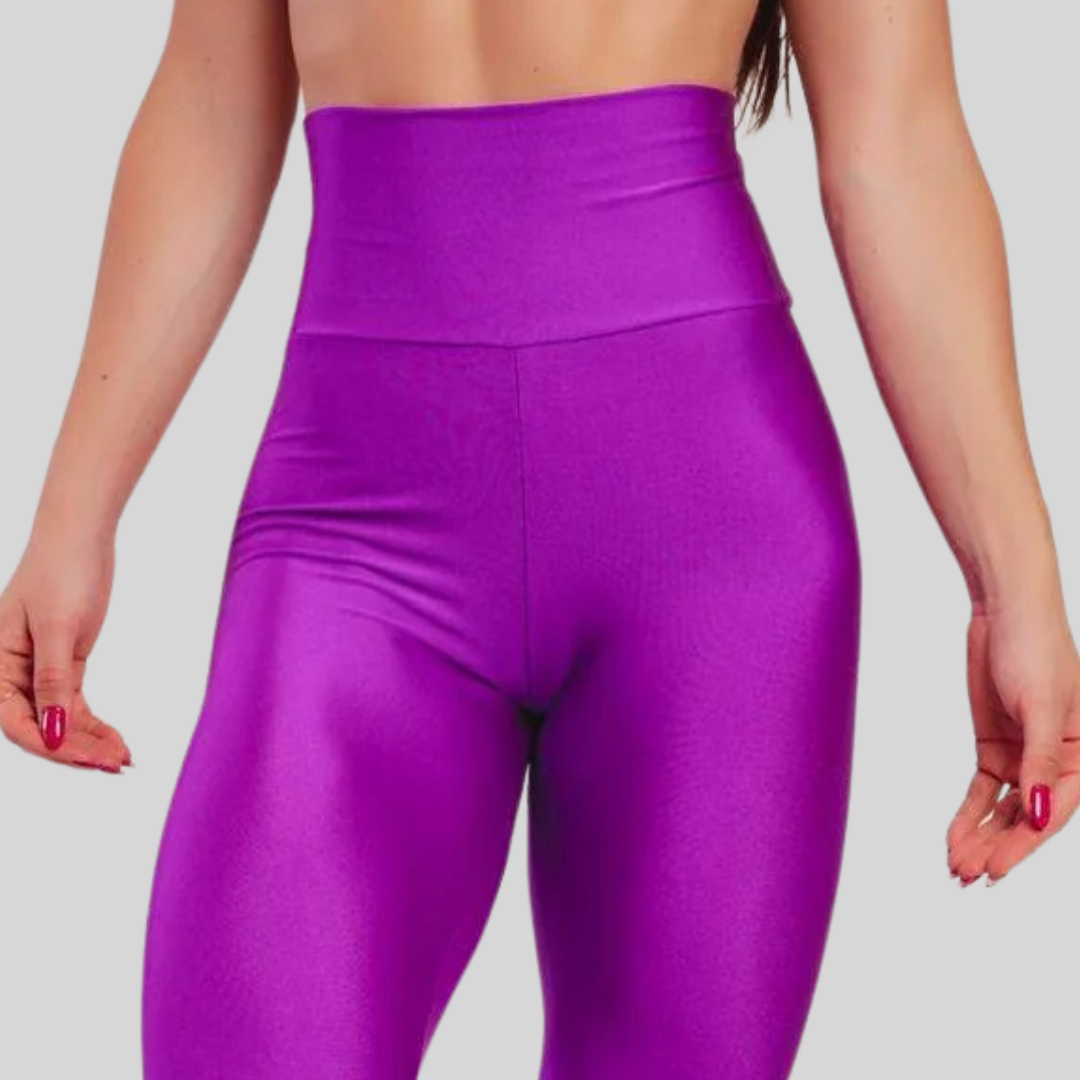 Purple leggings worn by a person on a plain background
