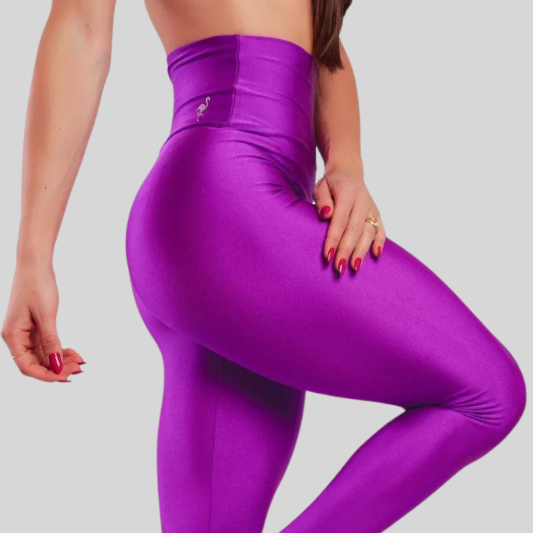 Person wearing purple leggings on a plain background